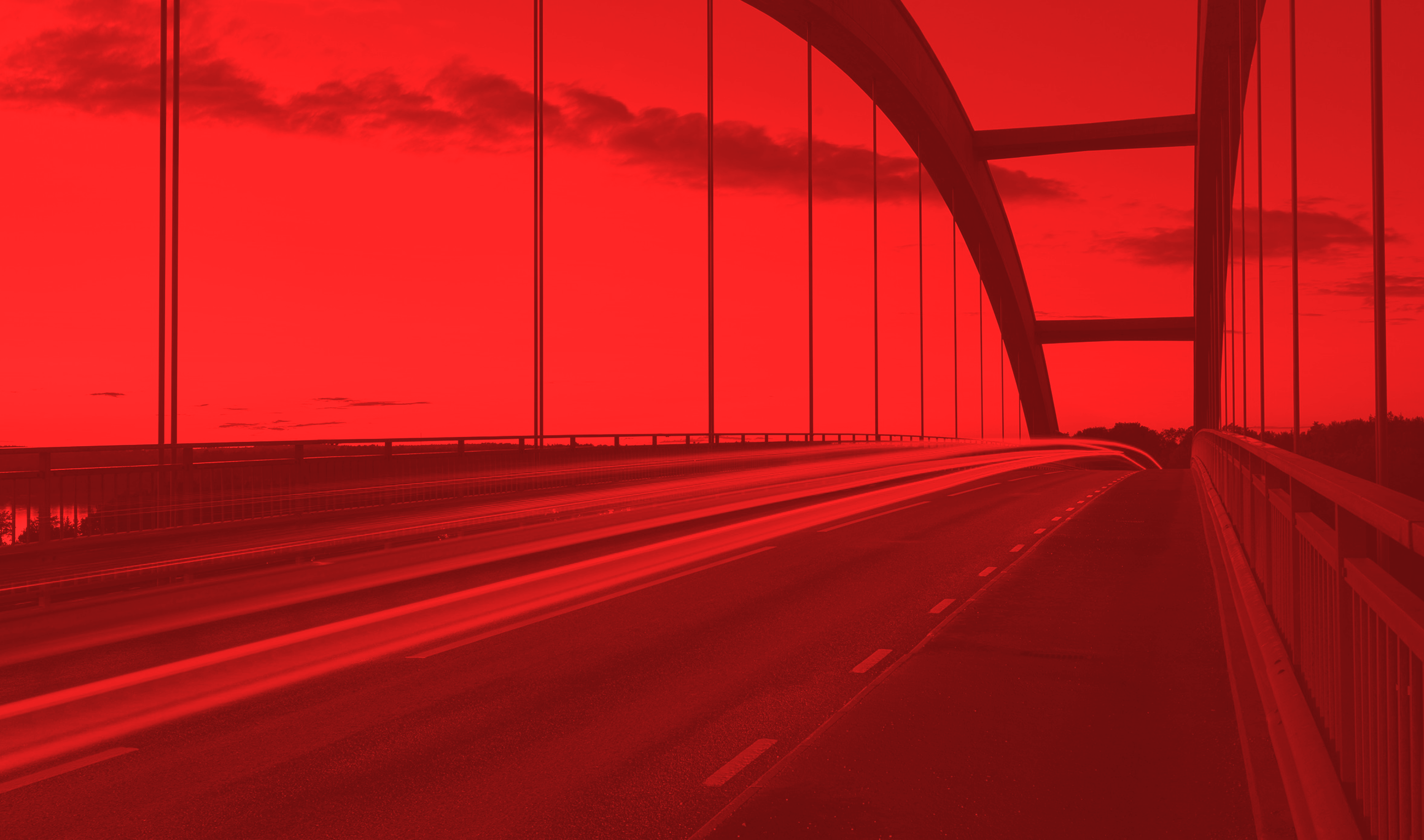 highway bridge with vehicles moving across it with a red mask