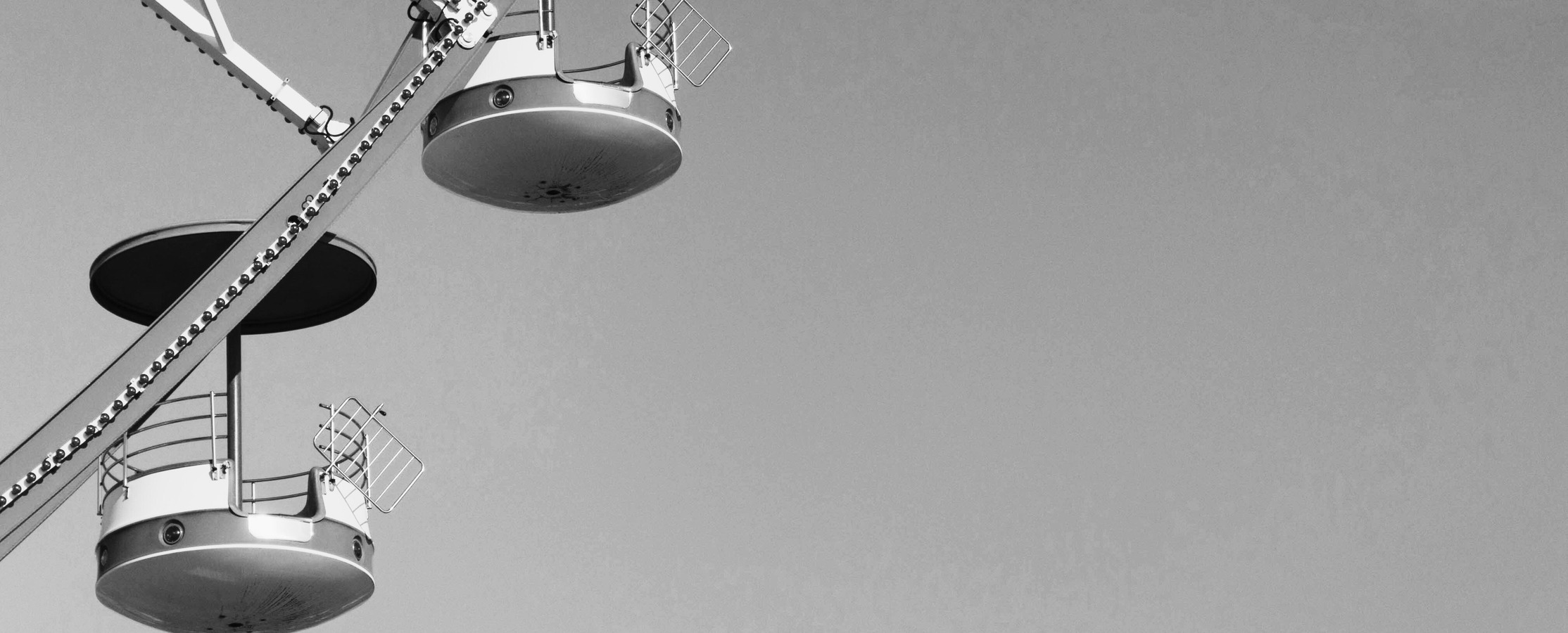 A black and white close up picture of a carousel.