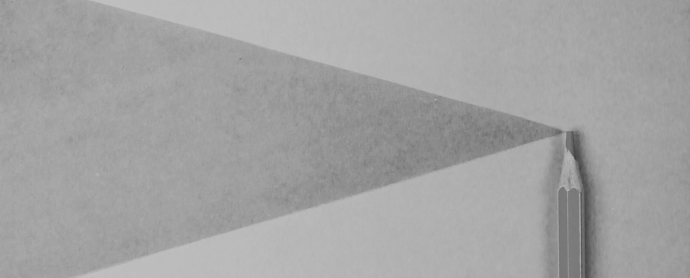 Gray pencil on white paper casting a triangular shadow.