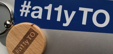 conference sticker and swag on a laptop cover.