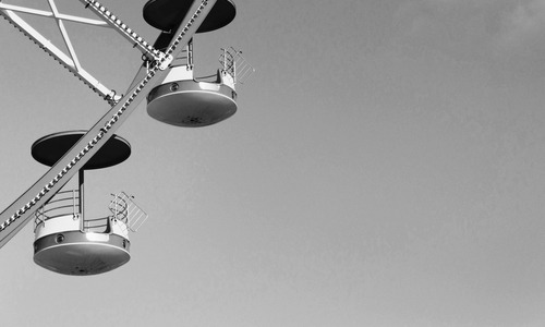 A black and white close up picture of a carousel.