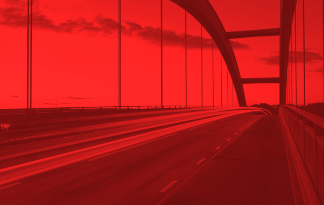 highway bridge with vehicles moving across it with a red mask