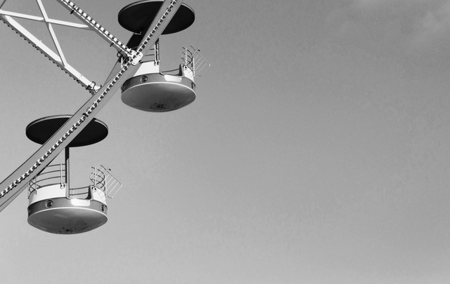 A black and white close up picture of a carousel.
