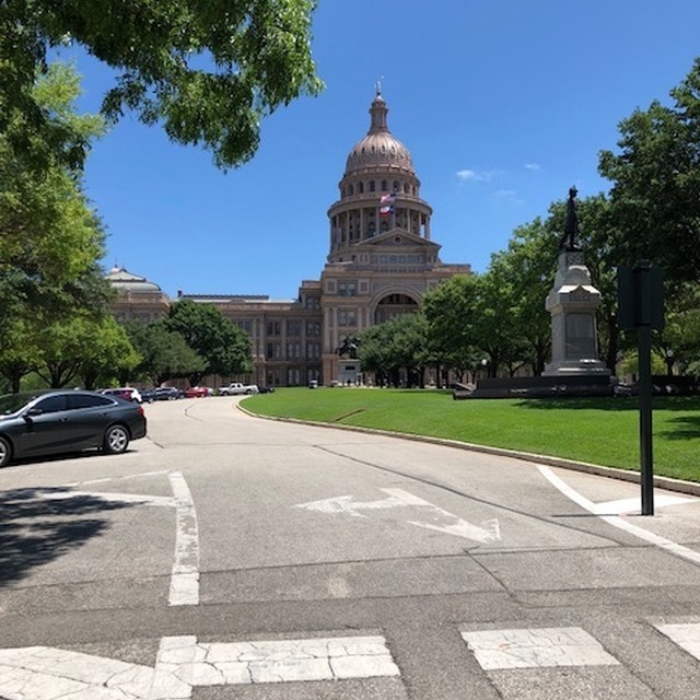 Angled shot from the entrance to the park with the State Capitol in the background